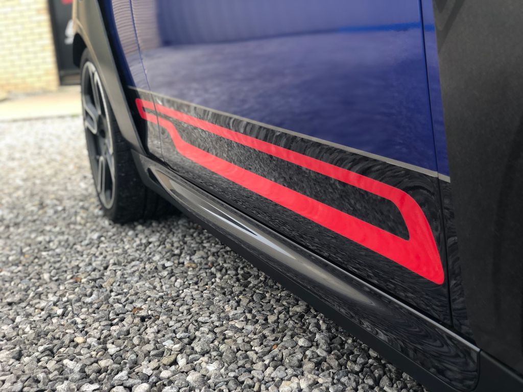 Blue Mini Cooper with red racing stripes.