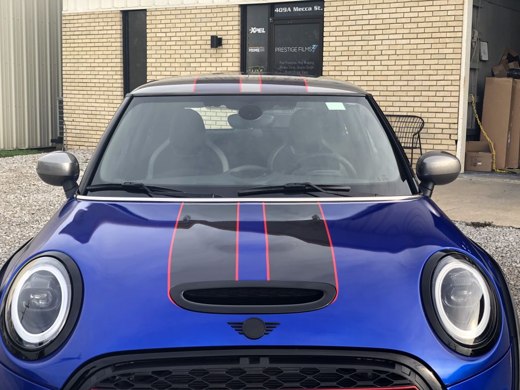Blue Mini Cooper with red racing stripes.