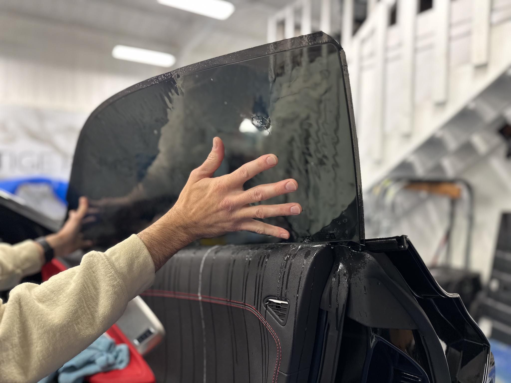 Applying ceramic window tint to a vehicle window in Lafayette, LA