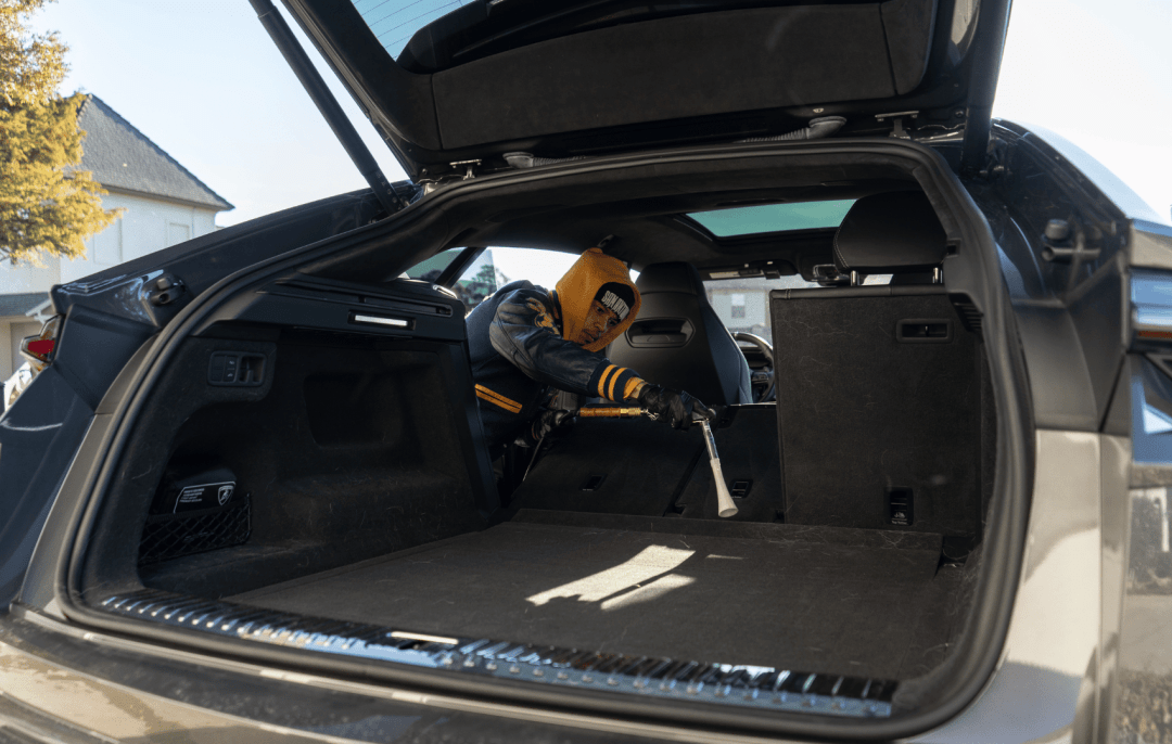 A detailer vacuuming the interior of a vehicle in Lafayette La.