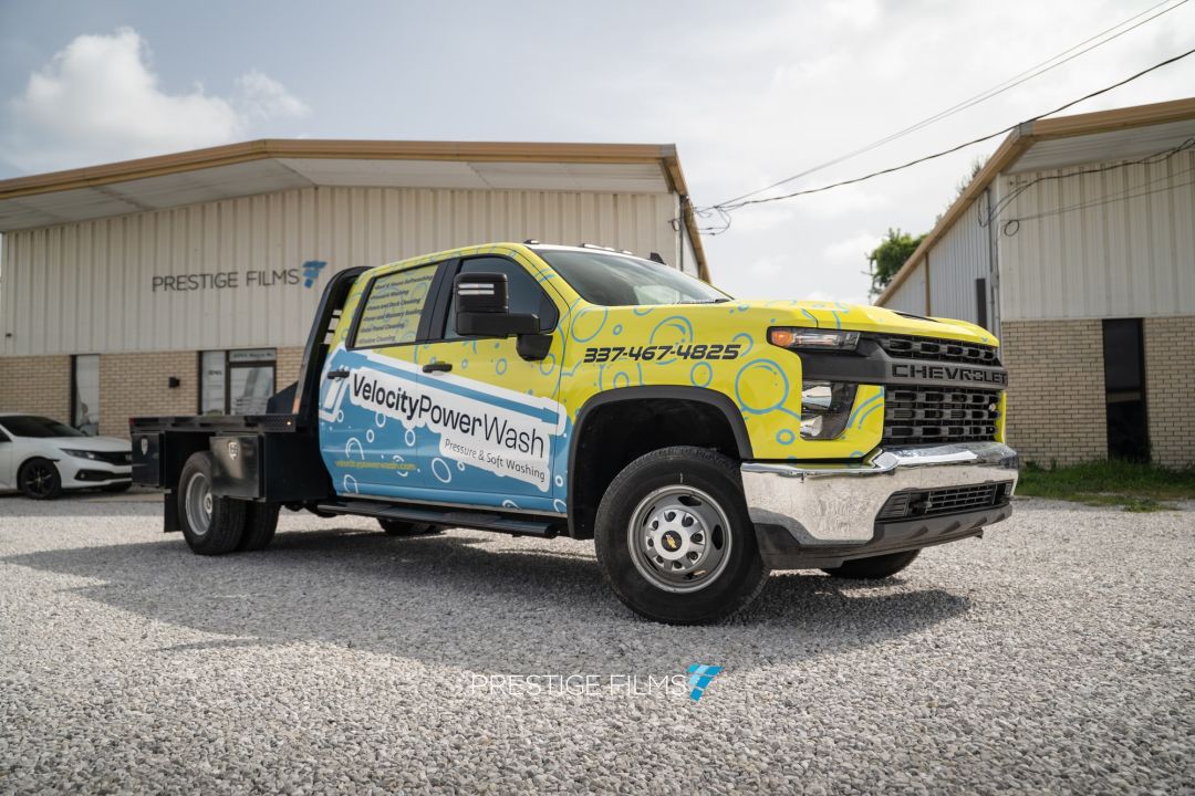 Velocity Power Wash flatbed truck with a printed vinyl wrap