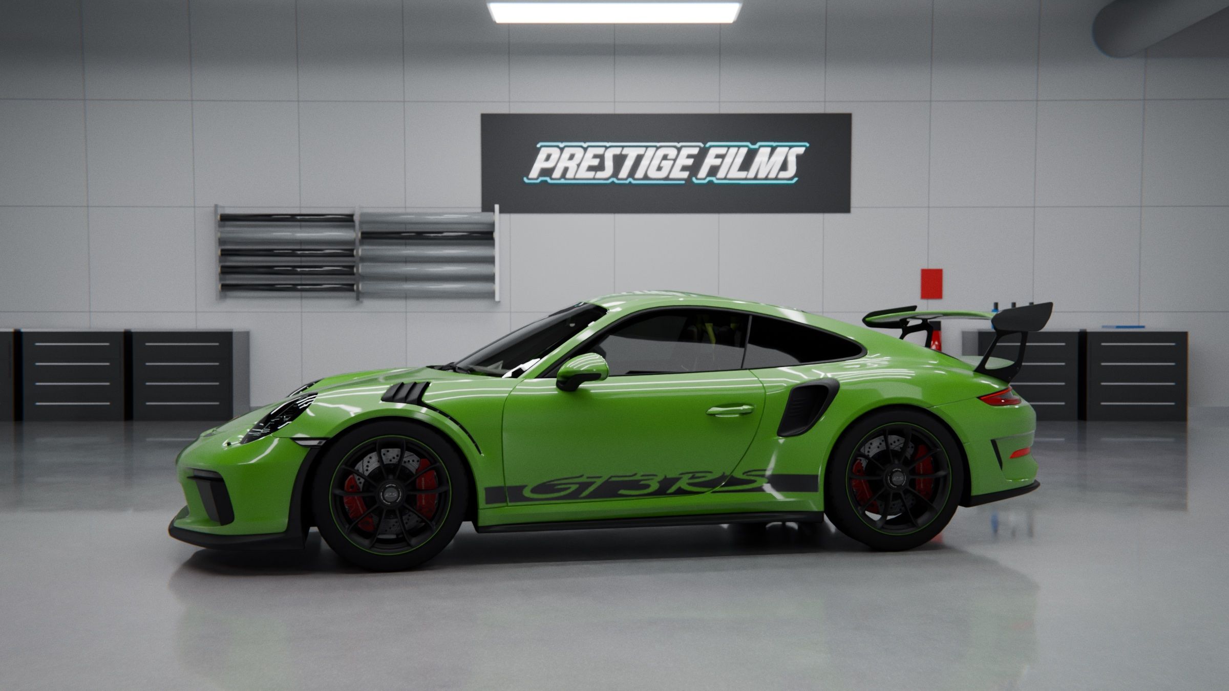 Bright green Porsche 911 GT3 RS in a clean gray workshop with 'Prestige Films' sign on the wall above the car's roofline.