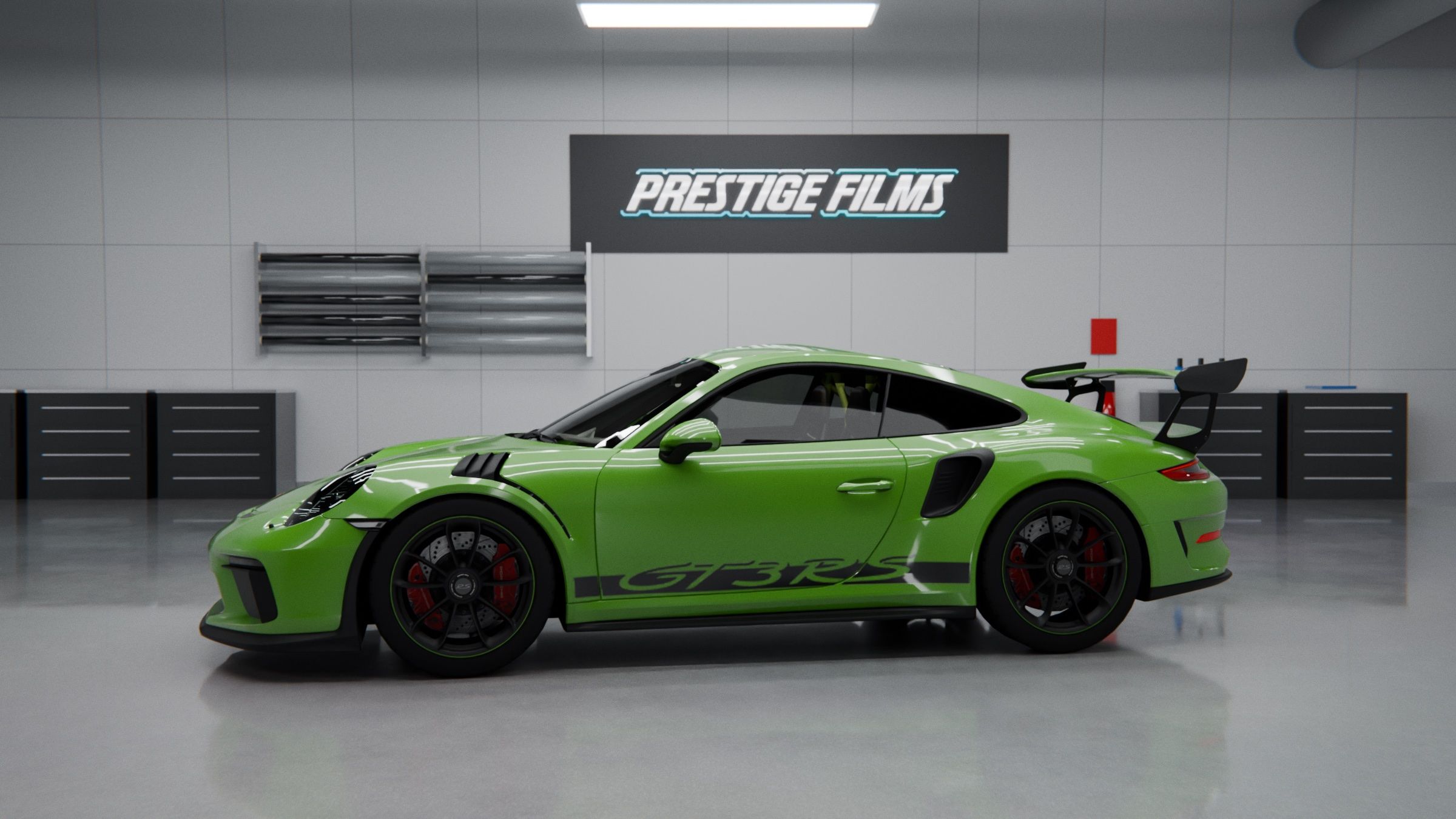 Bright green Porsche 911 GT3 RS parked in a clean garage with tool chests and a Prestige Films sign on the wall.
