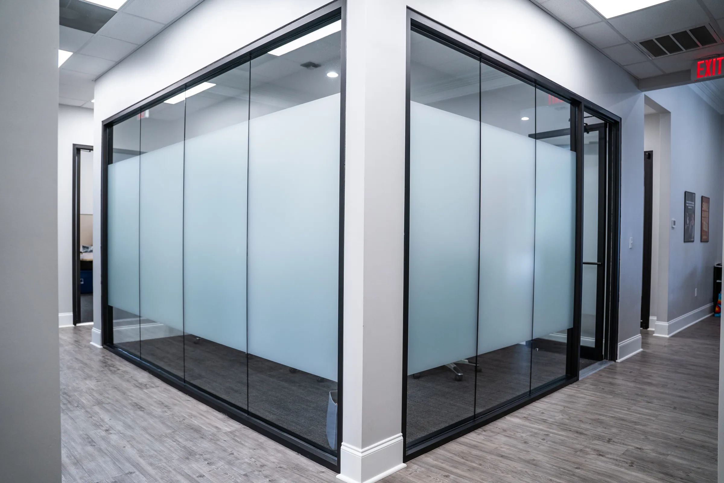 XPEL VISION White Frost window film on glass conference room walls in a Lafayette office