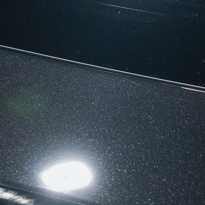 Close-up of the same spot after correction: clean metallic paint, no scratches or water spots