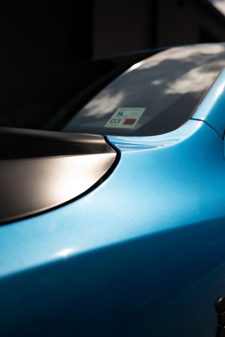 Close-up of the hood edge and fender on a blue Dodge Durango with paint protection film