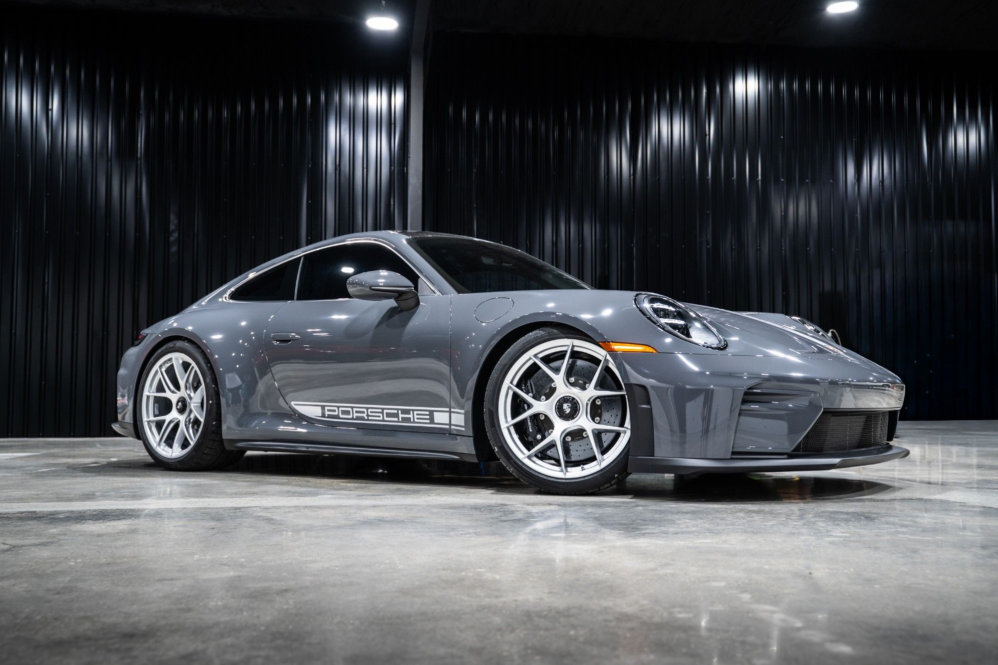 PPF hero – gray Porsche 911 - Prestige Films Gray Porsche 911 with silver wheels and Porsche side script in a dark studio