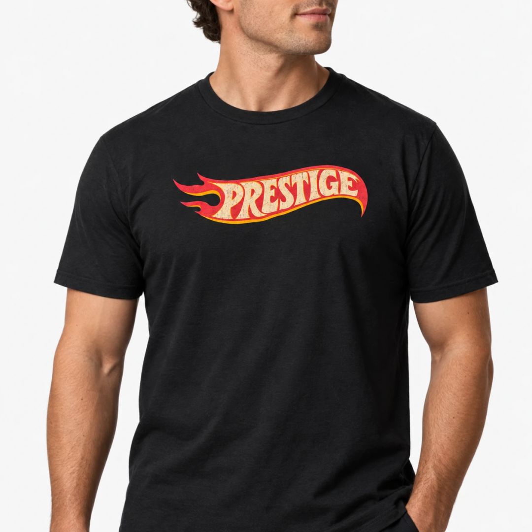 Black Prestige Flame Tee, front view, with the red and yellow flame Prestige logo across the chest